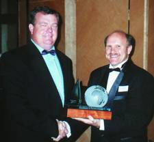 Norman Jackson recieves the award for 'Excellence inparterships from Peter Booysen